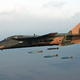 An F-11E of the 20th Tactical Fighter Wing drops bombs over a bombing range (US Department of Defense)